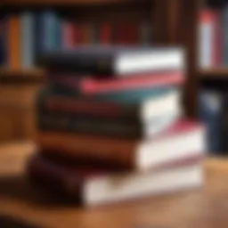 A stack of influential business books on a wooden desk